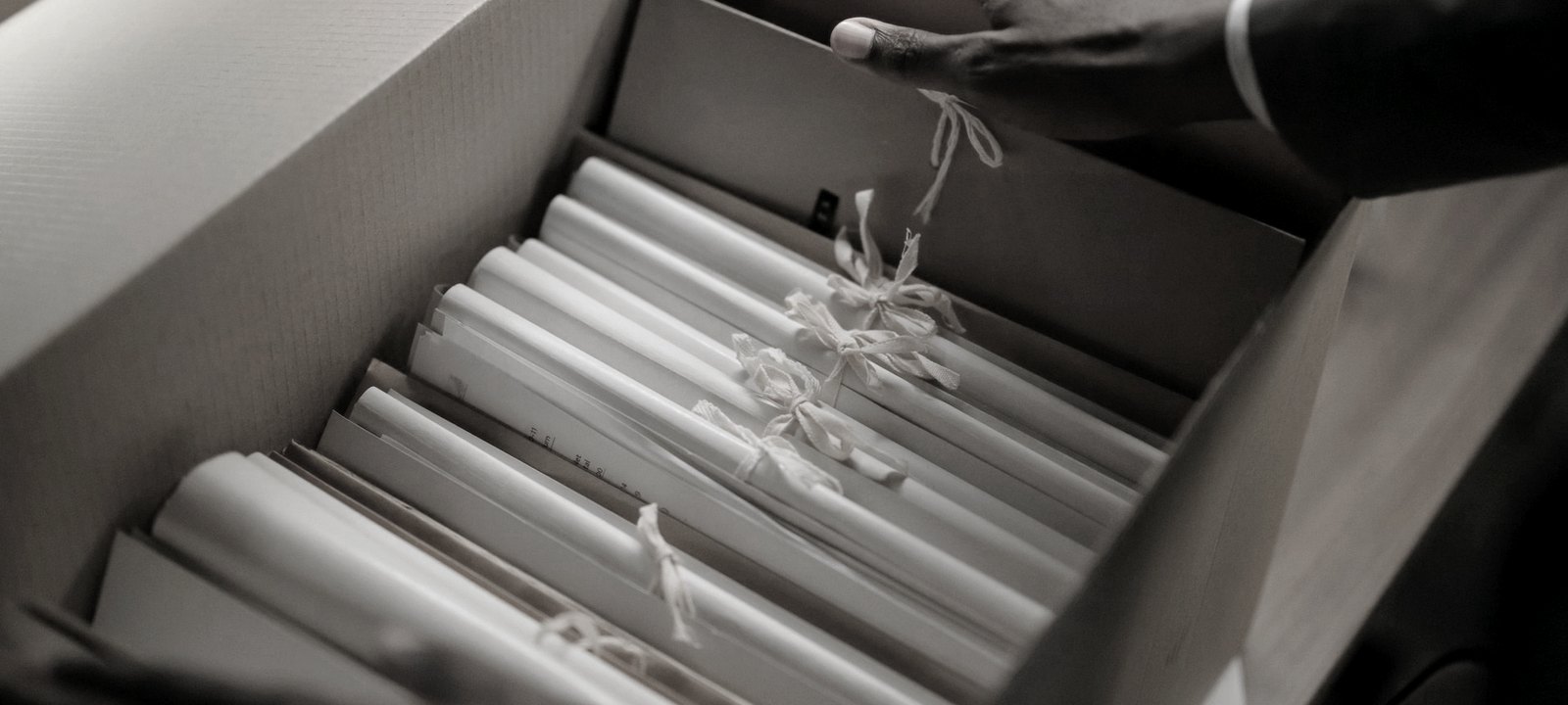 Symbolbild: Aktenrollen in einer Archivbox - Unterlagen für die Außenprüfung